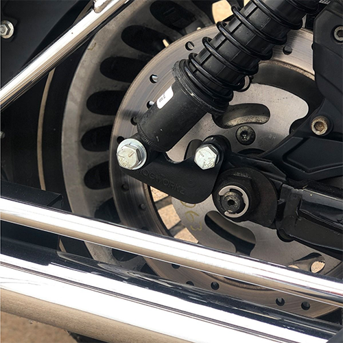 Close-up of a motorcycle wheel with suspension with lowering kit.