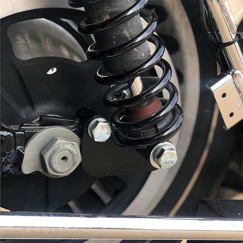 Close-up of a motorcycle suspension system with visible branding.