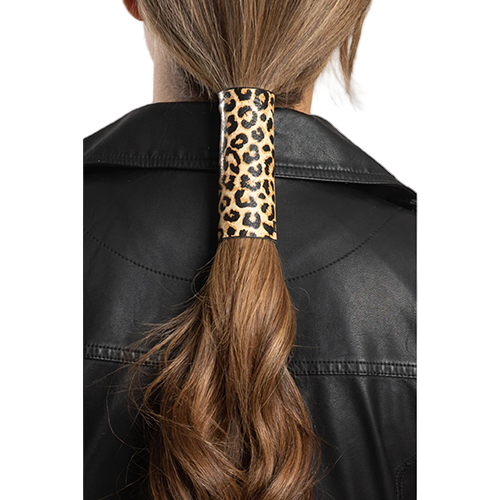 A person wearing a black leather jacket with a 4-inch leopard print leather hair glove in their hair.