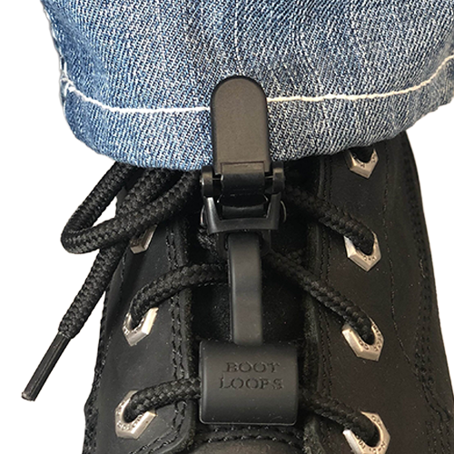 Black boot loops attached to a black boot with a person wearing blue jeans.