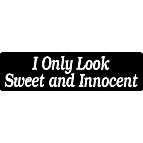A black helmet sticker with white text that reads 'I Only Look Sweet and Innocent'.