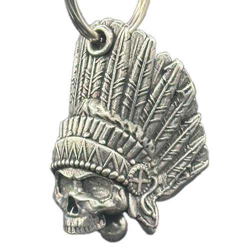 A silver-colored motorcycle bell with a skull design featuring Native American-inspired details, attached to a small round ring.