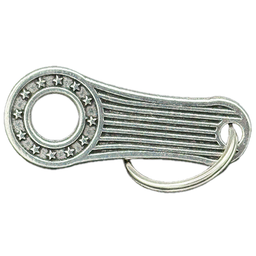 A pewter bell hanger with a patriotic design featuring stars and stripes, including a mounting split ring.