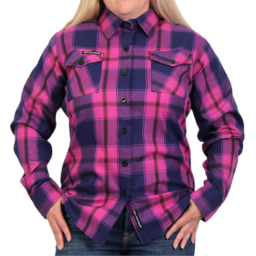 A woman wearing a long-sleeved flannel shirt with a plaid pattern in pink, navy, and brown colors, buttoned at the front.