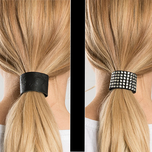 Two ponytail holders, one with a debossed skull pattern and the other with bling embellishments, displayed on a woman's hair.