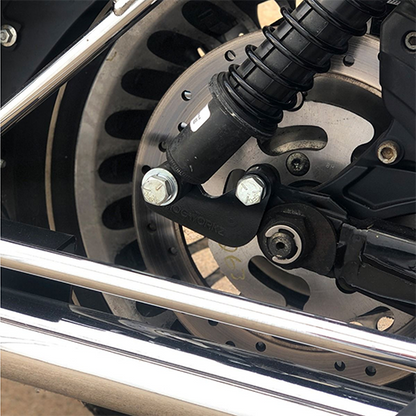 Close-up of a motorcycle wheel with suspension with lowering kit.