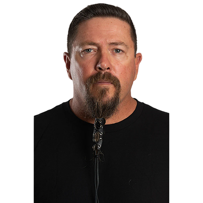 A person with a beard wearing a black full-grain leather beard glove with a lace-up design.