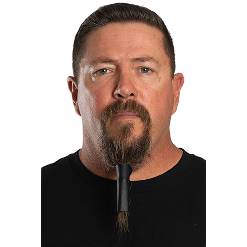 A man with a beard wearing a solid black beard glove.