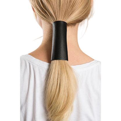 A person with a ponytail wearing a black leather hair glove.