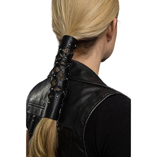 A person with blonde hair styled with a black leather hair glove featuring diamond cut-out pattern and lace details.