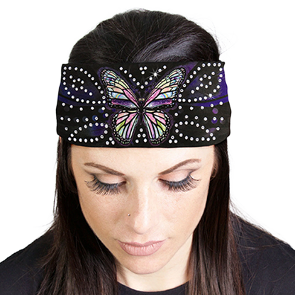 Woman wearing a headband with a butterfly design and rhinestones.