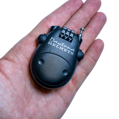 Small black combination lock held in a hand.