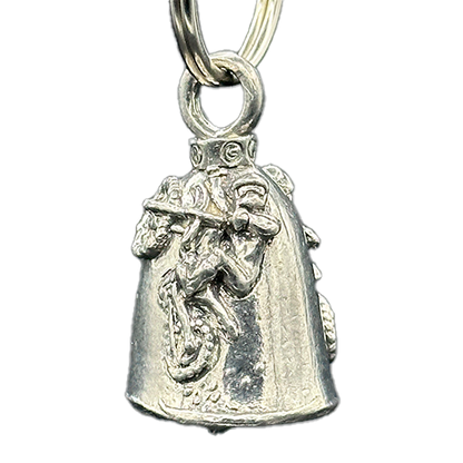 A silver motorcycle bell with a figure of a person riding a dirt bike on it.