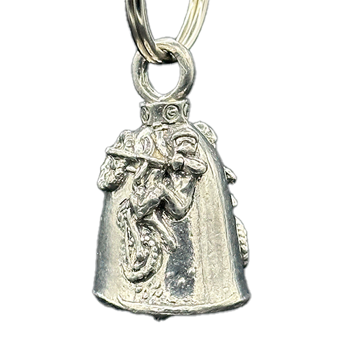 A silver motorcycle bell with a figure of a person riding a dirt bike on it.