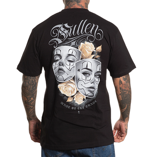 A person wearing a black crew neck t-shirt with a graphic design of two dramatic faces surrounded by golden roses on the back.