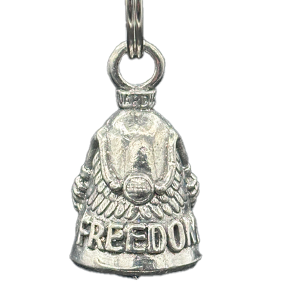 A silver bell with the word 'Freedom' inscribed on it and wings on the handlebars. The bell has a classic bell shape with a chain for attaching to a bike.