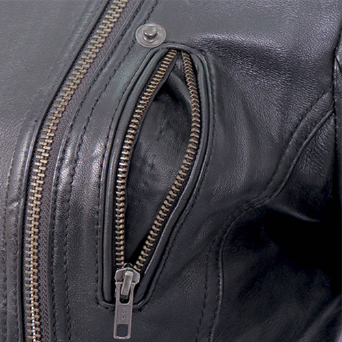 Close-up of antiqued YKK zippers on womens leather jacket chest