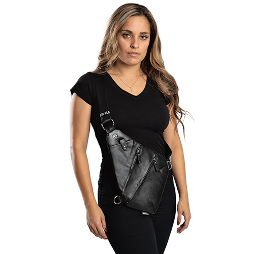 Woman wearing a black top and carrying a black crossbody bag.