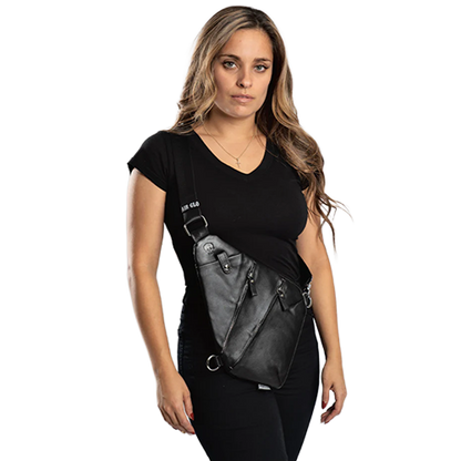Woman wearing a black top and carrying a black crossbody bag.