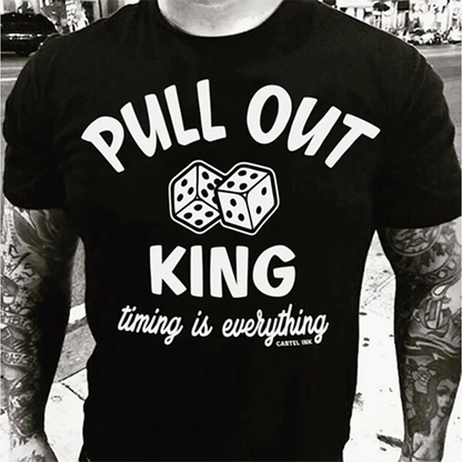 Black t-shirt with white text and dice graphics worn by a person with tattoos.