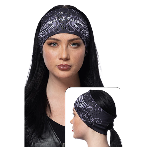 A woman wearing a black headband with a wings of freedom design and sparkling gemstones.